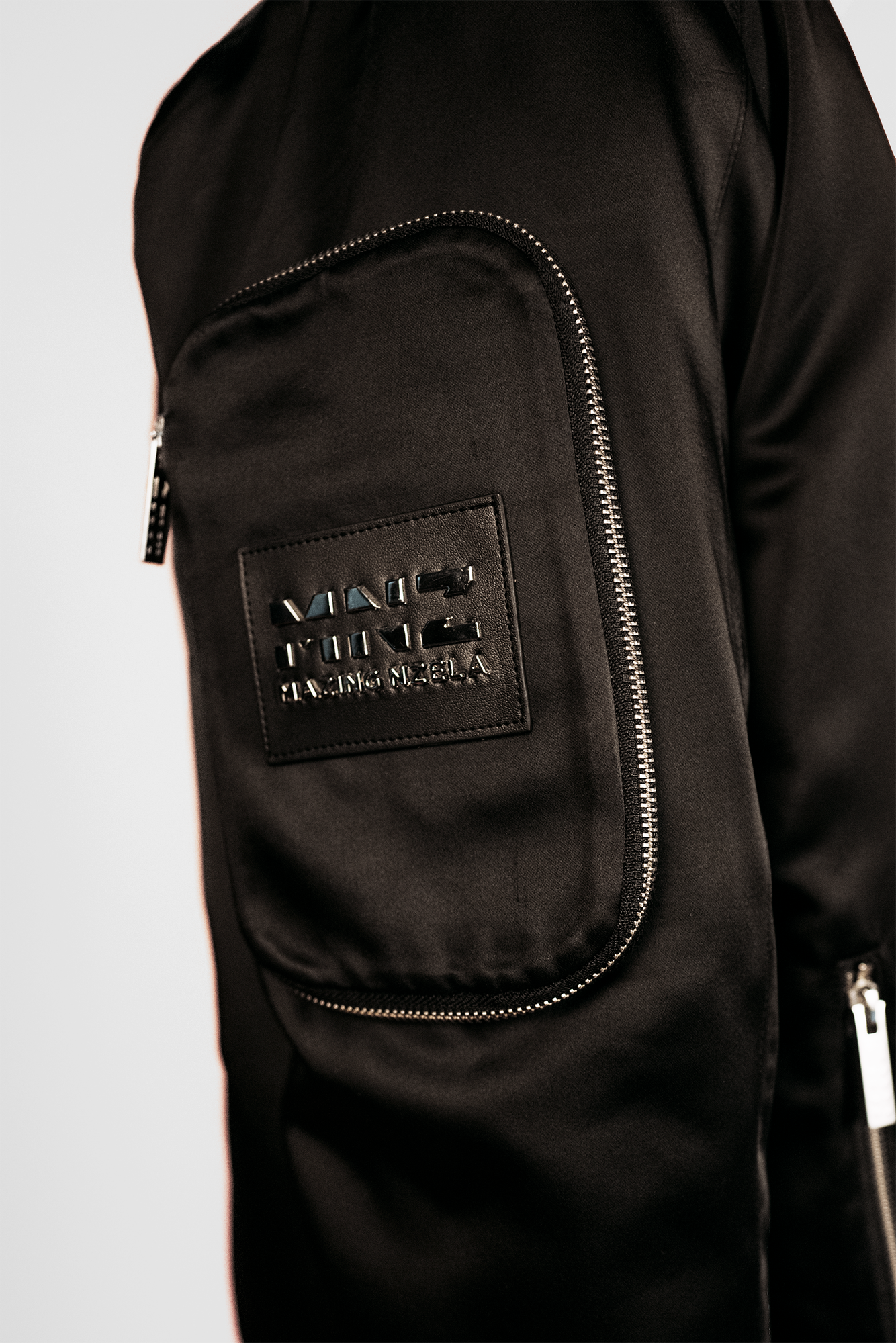 Men's bomber jacket with 3D cargo pockets, convertible crossbody bag, modular streetwear design, versatile and functional.