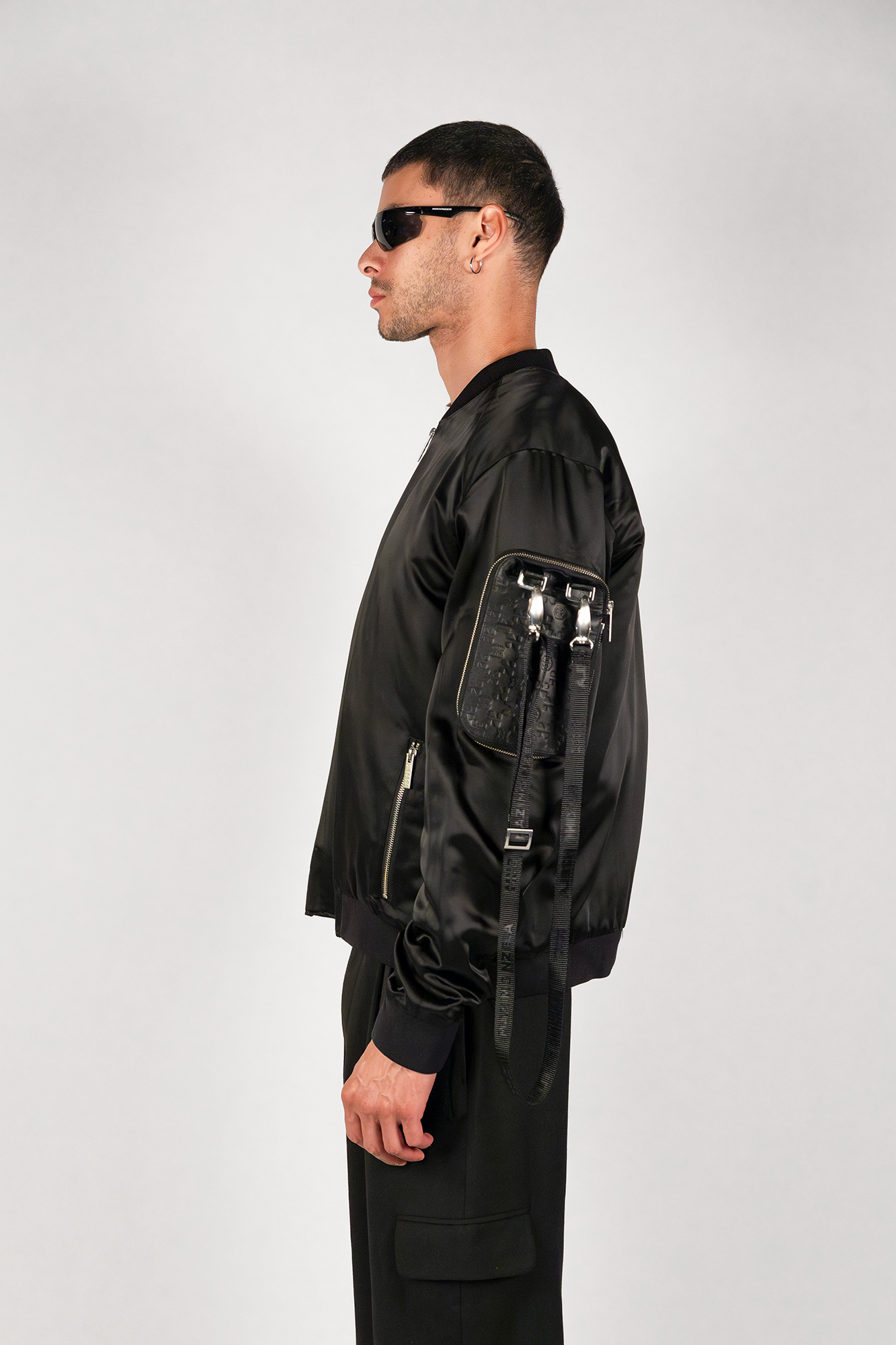 Men's bomber jacket with 3D cargo pockets, convertible crossbody bag, modular streetwear design, versatile and functional.